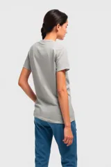 Remera negra con estampado de una mujer sentada en un sillón con un trago en la mano.