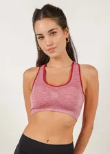Top deportivo rosado con espalda cruzada, breteles anchos y copas forradas con relleno extraíble.