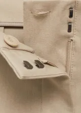 Pantalón de vestir color beige de corte palazzo, tiro medio y tejido ligero.