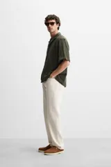 Camisa verde militar de manga corta con cuello bowling, corte relaxed fit y cierre frontal con botones.