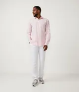 Camisa celeste de lino con cuello camisero, abotonadura frontal y mangas largas.