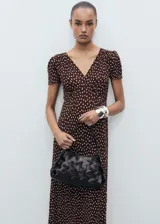 Vestido midi marrón con estampado de lunares blancos, escote en V, mangas cortas abullonadas y corte entallado.