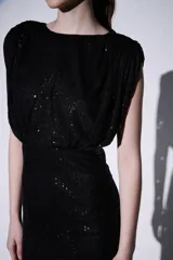 Minivestido negro de lentejuelas con corte ajustado y mangas cortas.
