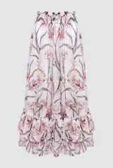 Falda midi de gasa color blanco con estampado floral en tonos rosados y marrones. Presenta cintura elastizada y volados en el ruedo.