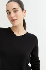 Sweater color camel de tejido de punto con escote en V y detalle de crochet en el borde. De manga larga y corte recto.