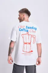 Remera blanca de manga corta con corte oversize y estampa en la espalda con la frase "Chill Sunday Coffee Club" y una cafetera italiana.