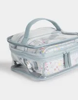 Neceser transparente con estampado floral, con manija superior y doble cierre.