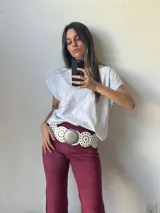 Pantalón de gamuza color borgoña, de corte ajustado y con aberturas en el ruedo.