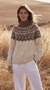 Polerón de punto tejido a mano en lana merino, con cuello alto y diseño de guarda nórdica en el canesú en tonos marrón y crema.