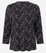 Blusa de mangas 7/8 confeccionada en viscosa sostenible, con cuello redondo y estampado de semicírculos blancos sobre fondo negro.