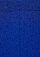 Pantalón de vestir azul eléctrico, de corte recto y tejido con textura. Presenta cintura elástica.