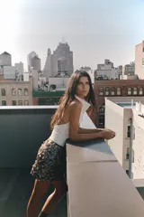 Falda corta de corte recto, completamente cubierta de lentejuelas redondas en tonos plateados y marrones/bronce. Posee forro interior y cierre lateral oculto.