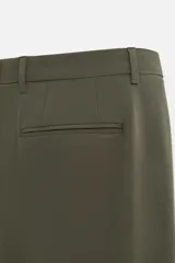 Pantalón de vestir azul marino, de corte slim fit, con bolsillos laterales y traseros de vivo con botón. Se ajusta a la cintura con cierre frontal con cremallera y botón.