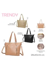 Bolso tipo shopper color beige con doble asa de hombro y correa extraíble regulable. Tiene dos bolsillos frontales con cierre y detalle de la palabra 'TRENDY' grabada en el frente.