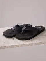 Ojotas negras para hombre con capellada textil de algodón y suela de goma EVA.