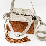 Cartera de cuero vacuno en combinaciones de color whisky y crocco arena, con manijas cortas y correa larga ajustable.