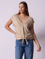 Blusa de modal con estampado de hojas en tonos azulados, escote en V con botones y ruedo anudado.
