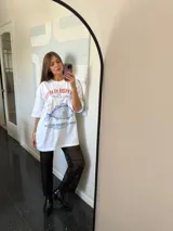 Remerón blanco oversize con estampado de un pez azul y texto en rojo y azul.