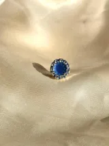 Caravana de resina azul con borde de strass plateado, de 1cm de diámetro. Se vende por unidad.