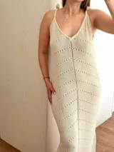 Vestido largo tejido con hilo de algodón y lurex color beige, con escote en V, tiras regulables en los hombros, espalda abierta y tajos laterales.
