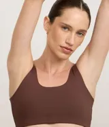 Top deportivo blanco de escote redondo y breteles medianos, sin copa ni estampa.