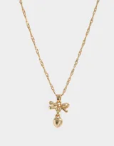 Cadena corta dorada con dije de moño con piedras de zirconia y dije de corazón colgante.