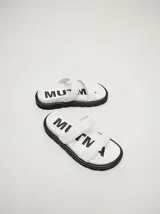 Sandalias blancas con doble tira ancha y plataforma negra.