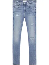 Jeans skinny de tiro bajo, color azul claro vintage con efecto desgastado y rotos en las piernas.