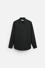 Camisa blanca de corte regular, cuello italiano, manga larga con puños abotonados y cierre frontal con botones.