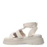 Sandalias bajas color beige con plataforma y tiras anchas con hebillas plateadas, estilo romano.