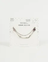 Pulsera doble de cadena plateada con dijes de luna, estrella y amatistas.
