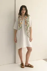 Vestido corto color arena, de lino, con escote en V y mangas cortas.