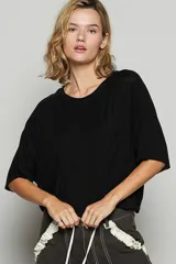 Remera negra de manga corta, corte holgado y bolsillo en el pecho.