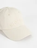 Gorra de gabardina negra con efecto lavado y bordado frontal con la palabra "Stories". Ajuste trasero con hebilla metálica.