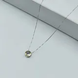 Conjunto de collar y aros con dije circular en plata y oro con circonias.