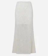 Pollera de largo new midi confeccionada en tejido de punto con aplicación de lentejuelas en toda la prenda. Presenta un diseño ajustado al cuerpo, forro interno y cintura elástica.