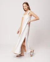 Vestido largo de lino con escote recto y breteles, detalles de elástico en la espalda y tajos laterales, en combinación de colores neutros y acentos.