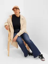 Jean de corte flare y tiro alto, en color azul oscuro con lavado uniforme. Presenta diseño clásico de cinco bolsillos, cierre frontal con botón y cremallera, y costuras en contraste.