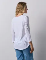 Remera celeste de modal con cuello cuadrado y apliques de aros metálicos.