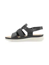 Sandalia negra con tiras de cuero y elástico con glitter, suela liviana y anatómica, tira trasera con velcro para ajuste.