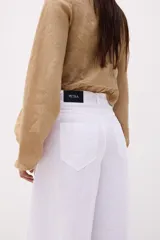 Pantalón celeste de lino, de corte amplio y tiro alto.