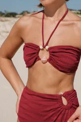 Top de bikini marrón con textura acanalada, tirantes finos que se atan al cuello y espalda, y detalle de cuentas de resina.