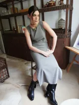 Vestido midi sin mangas, color gris, de tejido texturizado y corte recto, con abertura lateral en la falda.