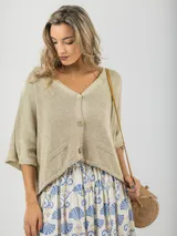 Cárdigan tejido color beige, talle único con calce oversized, con botones de madera y diseño relajado.
