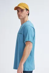 Camiseta celeste de manga corta con bolsillo en el pecho.