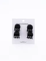 Set de cuatro pinzas pequeñas de plástico negro para el pelo.