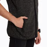 Chaleco de polar color gris jaspeado con cierre frontal, cuello alto, bolsillo en el pecho con cierre y bolsillos laterales con interior de polar.