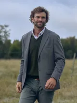 Saco sport de hombre color gris con textura, solapa de muesca, cierre de dos botones, bolsillo de parche en el pecho y bolsillos con solapa en la parte delantera.