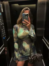 Minivestido de microtul elastizado con estampado abstracto en tonos verde, marrón y azul. Diseño ajustado al cuerpo, cuello alto y mangas largas.