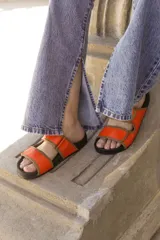 Pantalón de jean celeste de corte acampanado con aberturas en el ruedo.